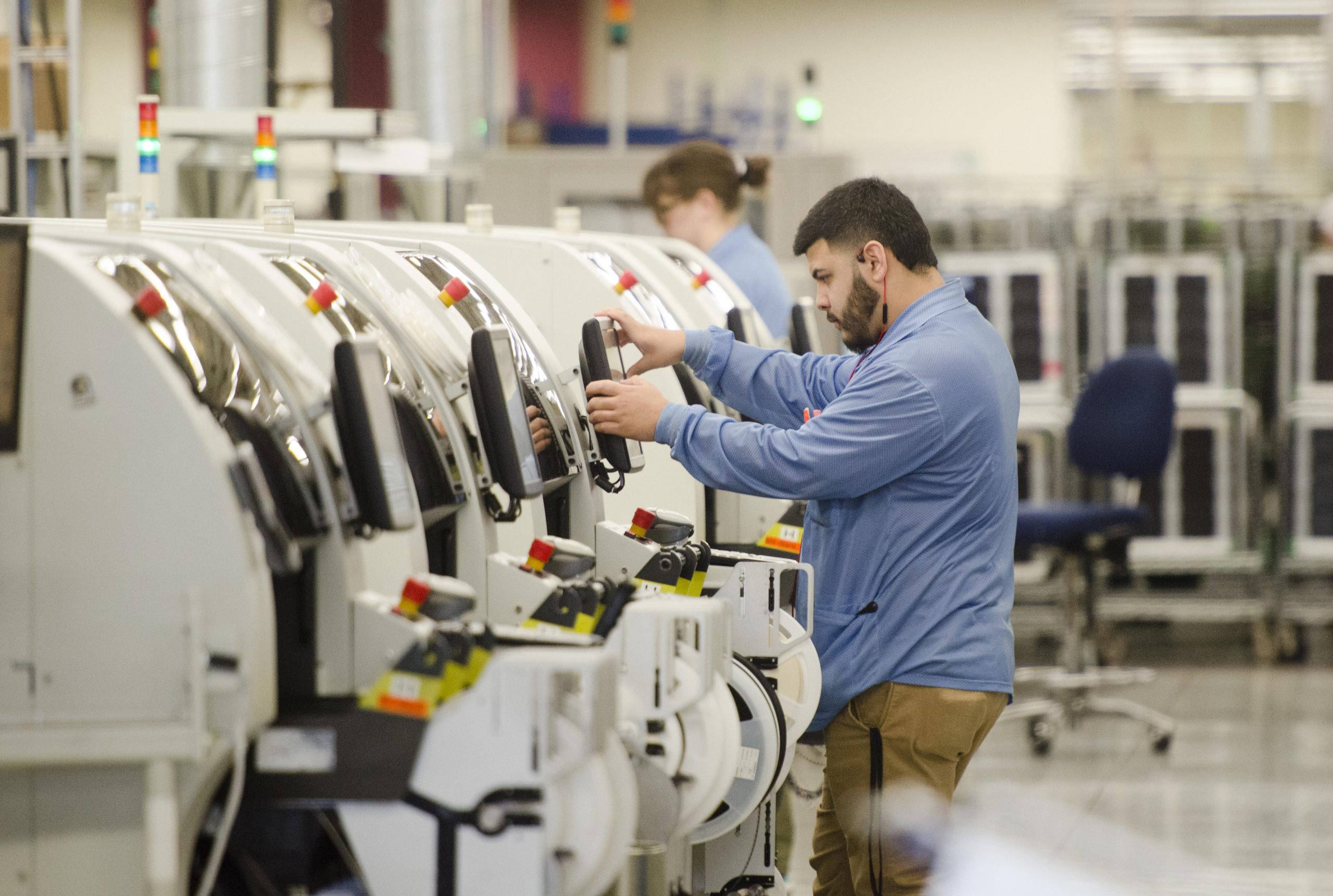An employee at Schweitzer Engineering Laboratories in Pullman moves among several machines making circuit boards that will go into equipment destined for the energy industry Tuesday, April 19, 2016. SEL has seen explosive growth in their products and their workforce in recent years.  JESSE TINSLEY jesset@spokesman.com